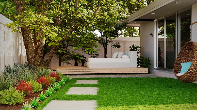 Low-maintenance backyard lawn in Alpharetta GA featuring lush green grass, shade trees, landscaped garden beds, and a modern outdoor seating area